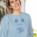 girl with baby blue color sweatshirt printed text chaos to clarity